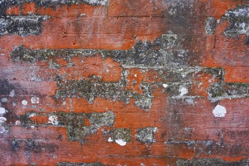 Dirty red brick wall with dark burnt patches horizontal architecture background texture