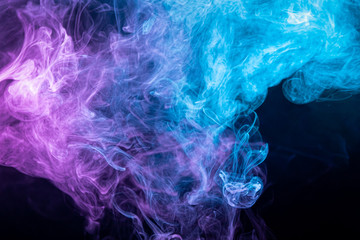 Dense multicolored smoke of   purple and blue colors on a black isolated background. ART for your design project. Transparent creativity