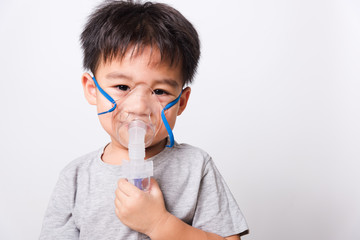 Closeup Asian face, Little children boy sick he using steam inhaler nebulizer mask inhalation...
