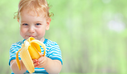 happy kid eating banana fruit