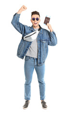 Happy male tourist with passport and tickets on white background