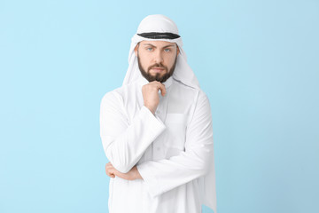 Handsome Arab man on color background