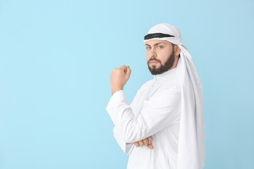Handsome Arab man on color background