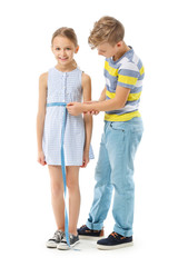 Cute little tailor with client on white background