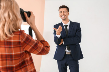 Naklejka premium Professional photographer working with model in studio