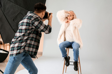 Professional photographer working with model in studio