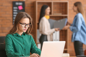 Beautiful young businesswoman working in office