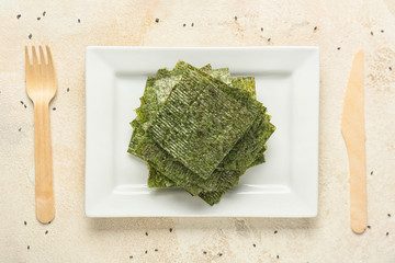 Plate with tasty seaweed sheets on table © Pixel-Shot