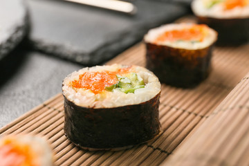 Tasty sushi rolls on table