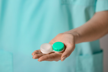 Woman holding container with contact lenses, closeup