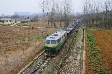 A narrow gauge train of Jiangnan Cement plant passes near Xianlin.