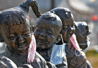 Fototapeta na wymiar In China, novel coronavirus pneumonia was released in February 23, 2020 in Huaian, Jiangsu province. Li Canal cultural corridor is a series of statues with masks.