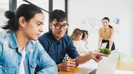 Asian business people working with laptop, searching data for business startup plan and strategy