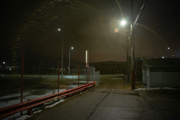 Dark and eerie urban city alley at night in the winter