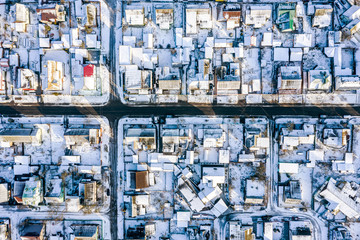 looking down from flying drone of houses roofs and streets. aerial landscape of residential area