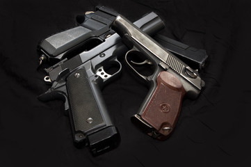 Air pistols on a black background