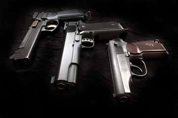 Air pistols on a black background