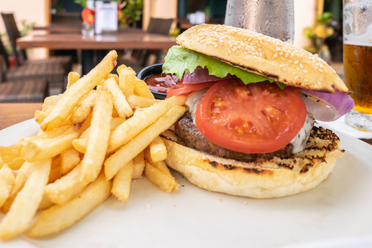Char-grilled Burger topped with lettuce, tomato, onion and French Fries in Kailua-Kona on Hawaii Island.