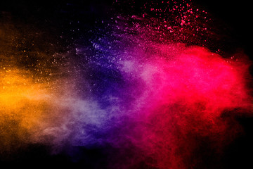 Freeze motion of colorful dust  particles splash. Painted Holi.