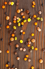 Different lentils on a wooden background. Top view.