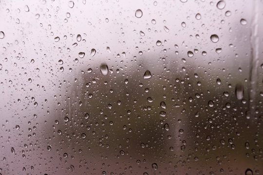 Textures of water droplets of rain flow down the windowpane. Rain drop on the car glass background, Blurred photo, Soft focus