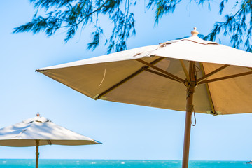 Obraz na płótnie Canvas Umbrella and chair around beach sea ocean