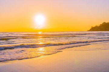 Fototapeta na wymiar Beautiful tropical beach sea ocean with sunset or sunrise for travel vacation