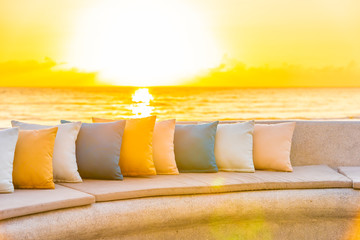 Comfortable pillow on sofa chair around outdoor patio with sea ocean beach view
