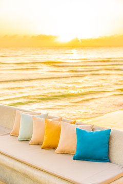 Comfortable pillow on sofa chair around outdoor patio with sea ocean beach view