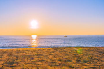 Beautiful tropical beach sea ocean with sunset or sunrise for travel vacation
