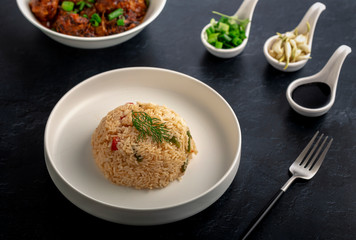  Vegetarian fried rice with manchurian served in a plate