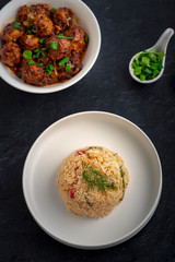  Vegetarian fried rice with manchurian served in a plate