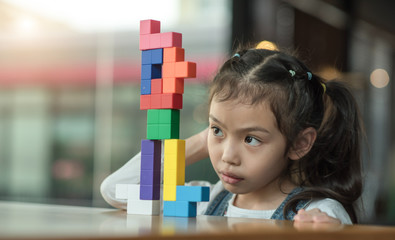 kid girl playing toy blocks. Concept of child meditation
