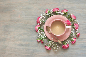 Cup of creamy coffee with flowers decor