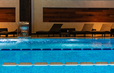 Modern blue on light backdrop. Water - swimming pool. Blue luxurious swimming pool. Swimming pool for luxury lifestyle design. Water - swimming pool. Luxury lifestyle. Natural pattern, luxury. Blue