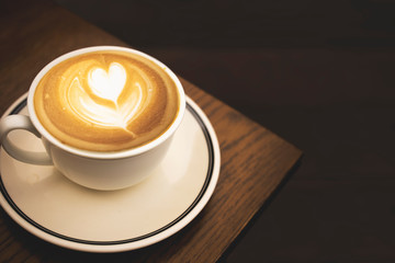 Coffee cup latte art coffee on wooden background. Top view with copy space.