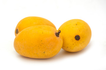 Group of tasty yellow mangoes on white background