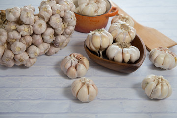 Garlic is placed on the white table in the kitchen, preparing for cooking, Concept: The ingredients of vegetarian ingredients are very much about nature for good health, background  aromatic herbs 