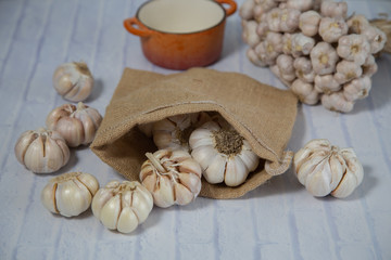 Garlic is placed on the white table in the kitchen, preparing for cooking, Concept: The ingredients of vegetarian ingredients are very much about nature for good health, background  aromatic herbs 