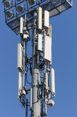 Telecommunication antenna tower for 4g and 5g cellphones on blue background