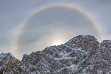 Halo over the Veliki Draski vrh mountain in the early morning viewed from the Zgornja Krma. Halo is  optical phenomena produced by light interacting with ice crystals suspended in the atmosphere.