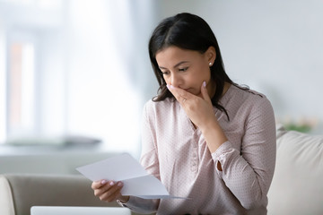 Unhappy biracial woman read bad news in letter