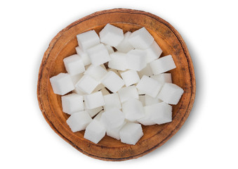 Wooden bowl of natural white sugar cubes on white background.