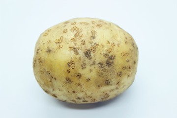 Raw beautiful potato is located on a white background