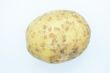 Raw beautiful potato is located on a white background