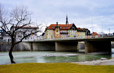 Isar river and bridge that leads to old town Bad Tolz, Bavaria, Germany.