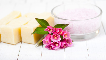 soaps, bath salts on white wood table