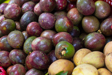 exotic fruits in Asia at the passion fruit market, beautiful, delicious fruit, different berries and vegetables laid out at the bazaar