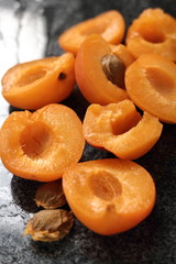 Fresh apricot halves on granite table