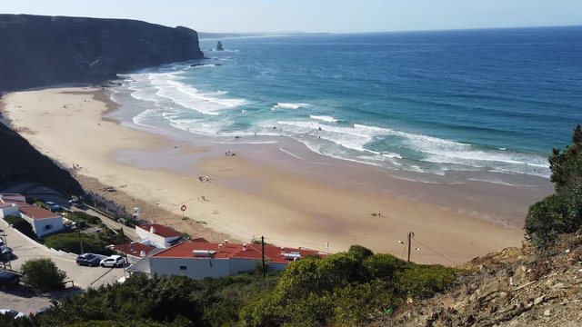 shot from above down to the paraia do arrifana at the algarve in protugal